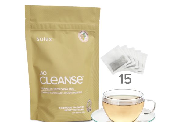 깨끗한 조리대 위에 허브차 한 잔과 AO 클렌즈 티백, 장 건강 관련 메모가 놓여 있다.