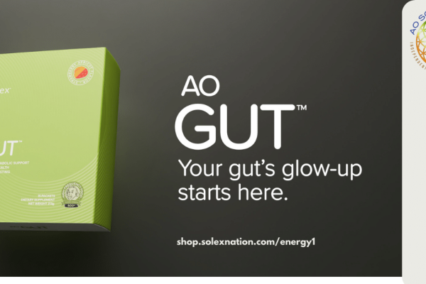 AO Gut Singles packet and a shaker bottle on a bright spring kitchen counter, ready to mix with cold water